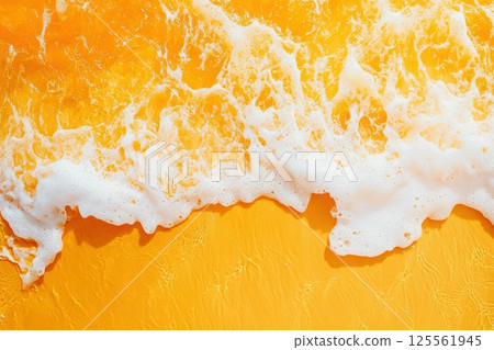 Overhead view of wave patterns on sandy beach at sunrise with warm tones and copy space 125561945