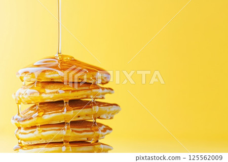 Flying pancakes stacked in mid air with syrup creating a delicious spectacle 125562009
