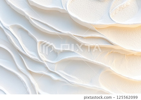 Stunning overhead view of wave patterns on sandy beach at sunrise with warm tones and copy space 125562099