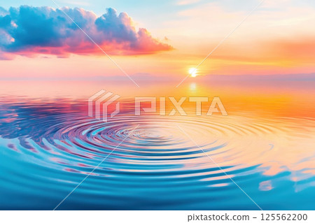 Circular ripples reflect the colorful sky at sunset over a calm lake surface 125562200