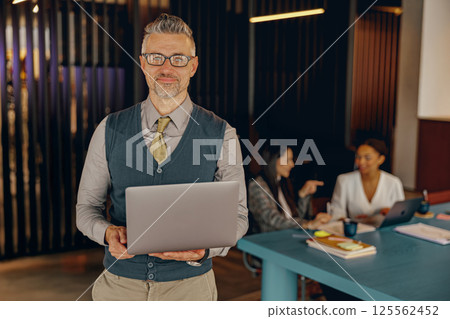 A Confident Businessman in a Modern Office that Embodies Professionalism and Success 125562452