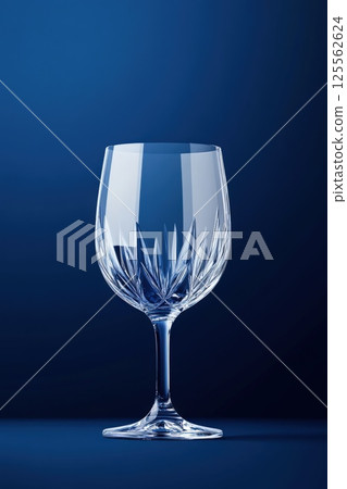 Elegant Czech crystal glass with intricate engravings on a deep blue background Elegant Czech crystal glass with intricate engravings on a deep blue background 125562624