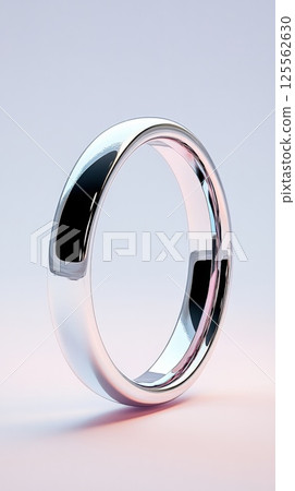 Sleek silver ring showcases minimalist elegance against a soft neutral background 125562630