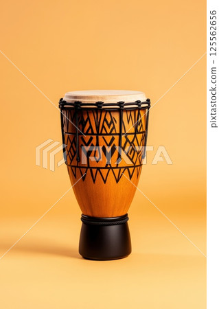 Intricate hand carved South African djembe drum with warm earthy tones and detailed tribal designs 125562656