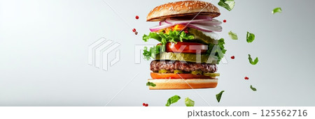 Juicy beef patty, fresh lettuce, ripe tomato slices, crunchy onion rings, tangy pickles, and sesame seed bun are exploding in a culinary symphony against a clean white backdrop 125562716