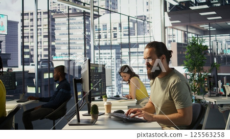 Annoyed programmer at work raging after losing all progress due to computer crash while creating machine learning models. Angry IT worker smashing desk in frustration while programming, camera B Annoyed programmer at work raging after losing all progress due to computer crash while creating machine learning models. Angry IT worker smashing desk in frustration while programming, camera B 125563258