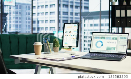 Empty luxurious corporate high end office designed for a CEO or leader, running analytics and data driven insights on screen. Urban global enterprise, business empowerment. Camera A. 125563293