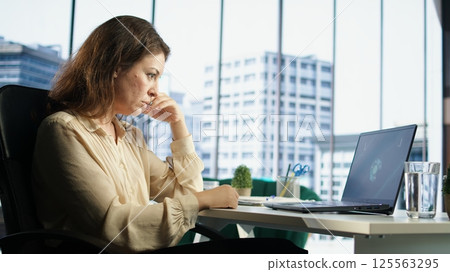 Woman general director managing multiple expansion projects, showcasing her multitasking abilities, organizational and leadership skills. CEO working with commitment to business success. Camera A. Woman general director managing multiple expansion projects, showcasing her multitasking abilities, organizational and leadership skills. CEO working with commitment to business success. Camera A. 125563295
