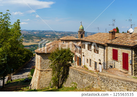 Scenic italian countryside village with historic stone buildings and rolling hills in Verucchio, Italy Scenic italian countryside village with historic stone buildings and rolling hills in Verucchio, Italy 125563535