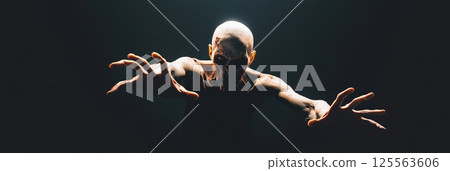Emerging from the shadows, a terrifying zombie extends its arms, creating a chilling and suspenseful scene against a dark backdrop, capturing the essence of horror and the undead 125563606