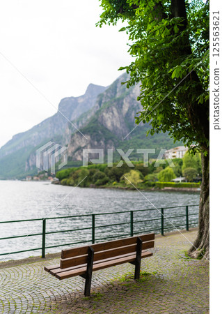 Scenic Lakeside Promenade with Benches and Mountain View 125563621