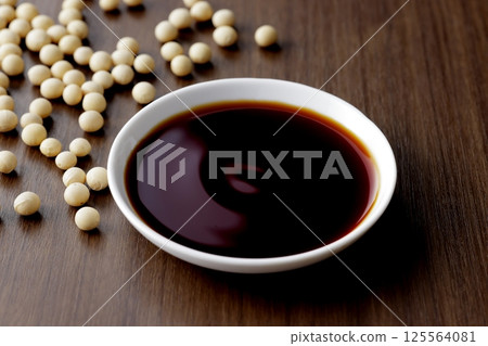 Pour soy sauce into a small plate Pour soy sauce into a small plate 125564081