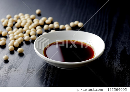Pour soy sauce into a small plate Pour soy sauce into a small plate 125564095