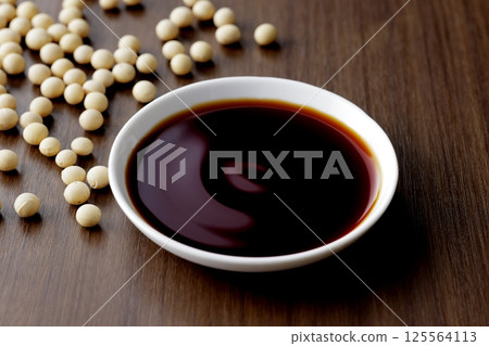 Pour soy sauce into a small plate Pour soy sauce into a small plate 125564113