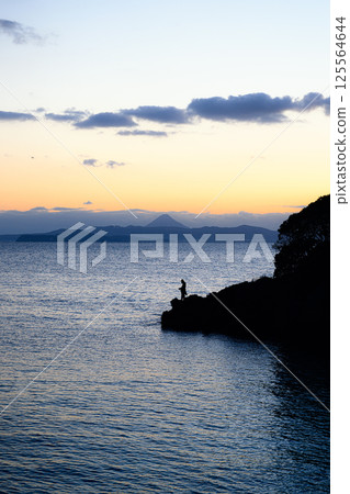 Silhouette of a fisherman and Mt. Kaimon, Kagoshima landscape 125564644