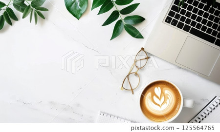 Flat lay of a marble desk with a laptop, latte art coffee, glasses, notebook, and green leaves. Clean and modern workspace from above AI generated 125564765