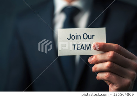business man holding paper card with join our team text. 125564809
