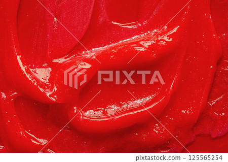 Red gel texture. Cosmetic clear liquid cream smudge. Skin care product sample closeup. Toothpaste or wax Red gel texture. Cosmetic clear liquid cream smudge. Skin care product sample closeup. Toothpaste or wax 125565254