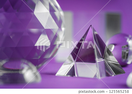 Crystal prism refracting light, magic crystals and pyramid, sphere and cube on purple background. Spiritual healing crystal practice. Feng Shui, good energy flow concept background.. 125565258