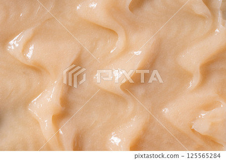 Body care balm, retinol serum, shampoo wavy texture. Hair conditioner cream background. Yellow cosmetic lotion moisturiser sample closeup. Skincare mask smear, creamy cleanser product Body care balm, retinol serum, shampoo wavy texture. Hair conditioner cream background. Yellow cosmetic lotion moisturiser sample closeup. Skincare mask smear, creamy cleanser product 125565284