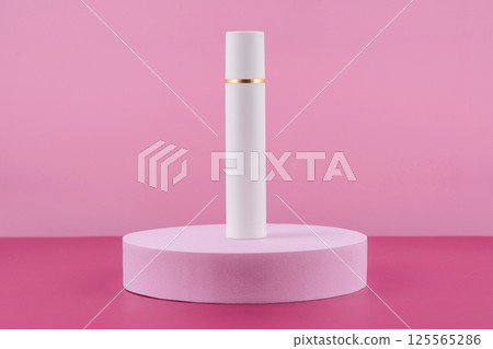 White pump cosmetic product on podium pedestal. Facial cream bottle on pink background, lotion in dispenser for woman skincare routine. Beauty moisturiser packaging. White pump cosmetic product on podium pedestal. Facial cream bottle on pink background, lotion in dispenser for woman skincare routine. Beauty moisturiser packaging. 125565286