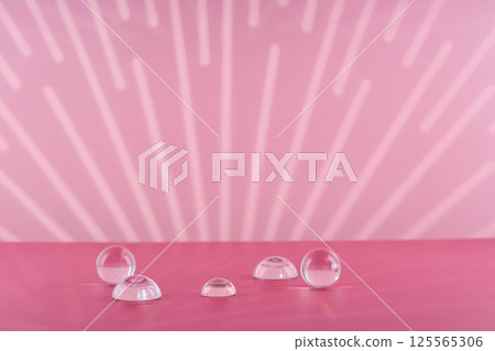 Cosmetic background podium for product presentation. Pink backdrop with transparent sphere decor, display balls mockup. Showcase mockup for perfume advertising, cosmetics stand 125565306