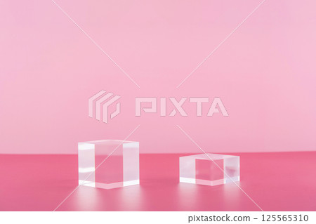 Acrylic blocks on pink background, pedestal cosmetic display glass podium platform for product presentation, geometric stand for cosmetics, mockup scene for jewellery 125565310