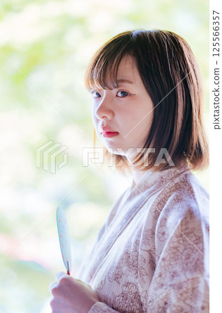Profile of a young woman wearing a yukata 125566357