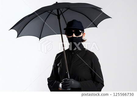 A woman dressed in black to protect herself from UV rays A woman dressed in black to protect herself from UV rays 125566730