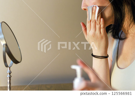 Middle-aged woman taking care of her skin Middle-aged woman taking care of her skin 125566981