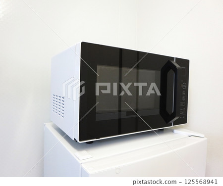 A convenient microwave oven for single use that can be placed on top of the refrigerator A convenient microwave oven for single use that can be placed on top of the refrigerator 125568941