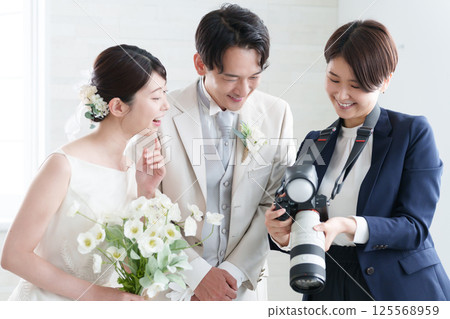Bridal photographer taking photos at a wedding 125568959