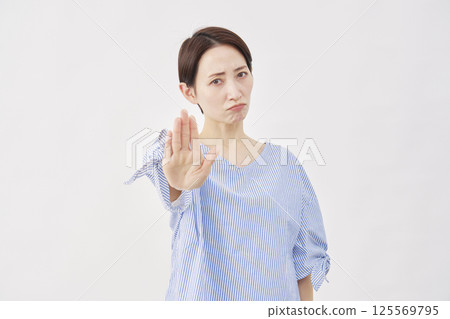 Woman, middle-aged, stopping gesture, white background 125569795