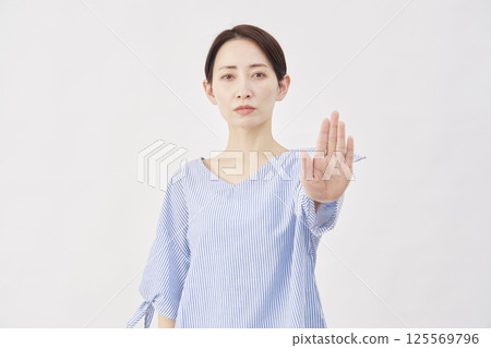 Woman, middle-aged, stopping gesture, white background 125569796
