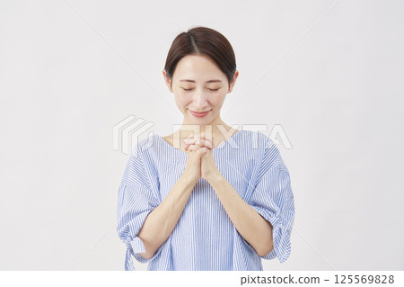 Woman middle-aged praying white background 125569828