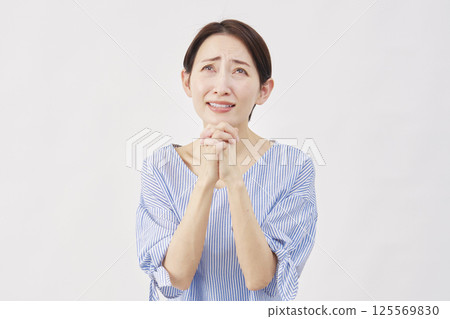 Woman middle-aged pleading white background 125569830