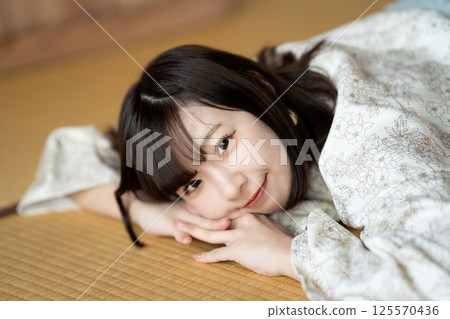 A young woman in a yukata resting in a tatami room A young woman in a yukata resting in a tatami room 125570436