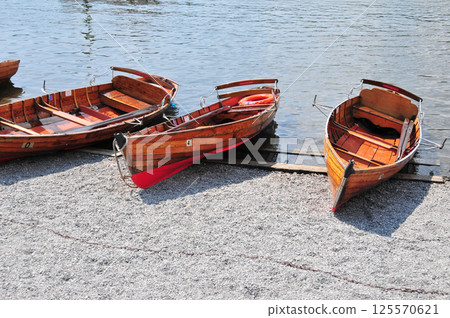 several wooden boats on the shore 125570621