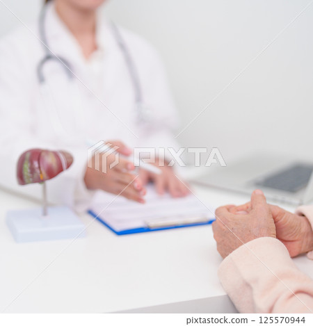 Doctor with human Liver anatomy. Elderly Patient consultation medical health for Liver cancer and Tumor, Jaundice, Viral Hepatitis, Cirrhosis, Failure, Enlarged, Hepatic Encephalopathy, Ascites Fluid 125570944
