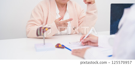 Doctor with human Liver anatomy. Elderly Patient consultation medical health for Liver cancer and Tumor, Jaundice, Viral Hepatitis, Cirrhosis, Failure, Enlarged, Hepatic Encephalopathy, Ascites Fluid 125570957