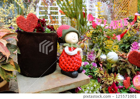 A strawberry figurine in a lovely garden 125571001