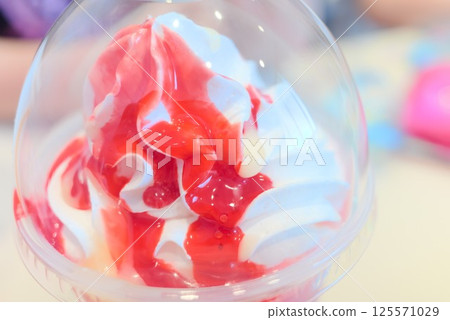 Close-up of strawberry sauce soft serve ice cream in a cup Close-up of strawberry sauce soft serve ice cream in a cup 125571029