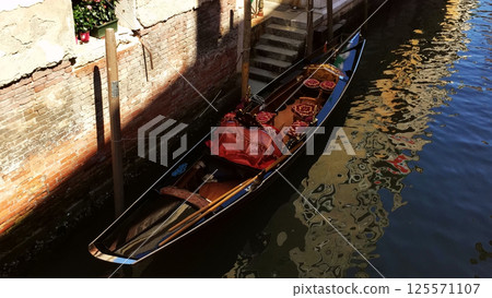 Photo of a gondola moored in Venice, Italy Photo of a gondola moored in Venice, Italy 125571107