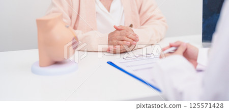 Elderly woman Patient consultation with doctor for Breast Augmentation Surgery, October Breast Cancer Awareness month, implant, Diagnosis, Beauty woman enlargement and medical healthcare concept 125571428