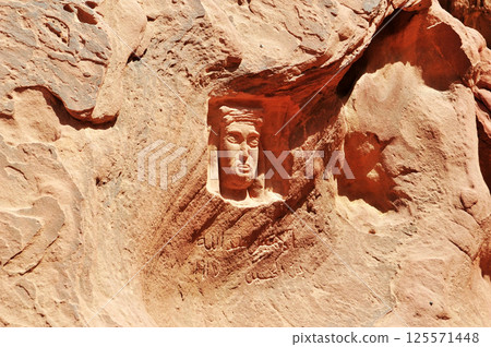 Ancient carvings on rocks in Jordan Wadi Rum desert. 125571448