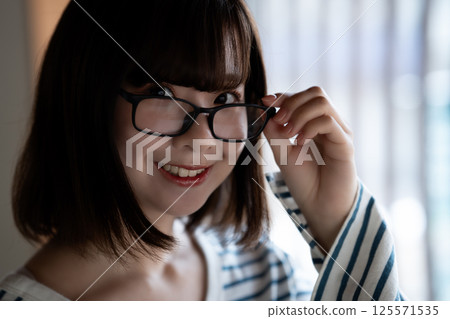 Cool young woman wearing glasses Cool young woman wearing glasses 125571535