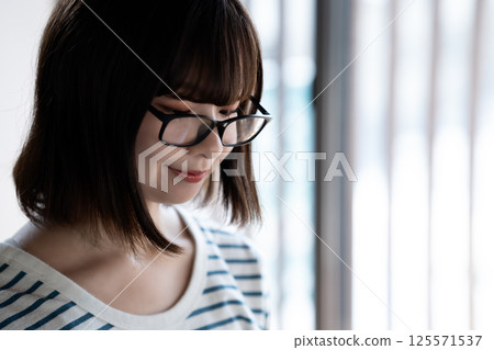 Cool young woman wearing glasses Cool young woman wearing glasses 125571537