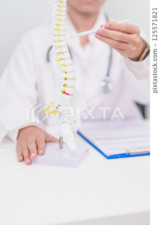 Elderly Patient consulting Doctor with Spine anatomy for Spinal Cord Disorder and disease, Back pain, Lumbar, Sacral pelvis, Cervical neck, Thoracic, Coccyx, Orthopedist, chiropractic, Office Syndrome Elderly Patient consulting Doctor with Spine anatomy for Spinal Cord Disorder and disease, Back pain, Lumbar, Sacral pelvis, Cervical neck, Thoracic, Coccyx, Orthopedist, chiropractic, Office Syndrome 125571821