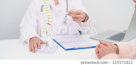 Elderly Patient consulting Doctor with Spine anatomy for Spinal Cord Disorder and disease, Back pain, Lumbar, Sacral pelvis, Cervical neck, Thoracic, Coccyx, Orthopedist, chiropractic, Office Syndrome Elderly Patient consulting Doctor with Spine anatomy for Spinal Cord Disorder and disease, Back pain, Lumbar, Sacral pelvis, Cervical neck, Thoracic, Coccyx, Orthopedist, chiropractic, Office Syndrome 125571822