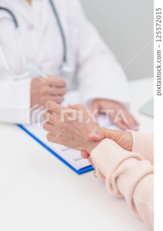 Elderly Patient Woman wrist pain and Consulting doctor. muscle ache from Carpal Tunnel Syndrome, De Quervain s tenosynovitis, rheumatoid, arthritis, gout, Parkinson disease and ergonomic healthcare 125572015